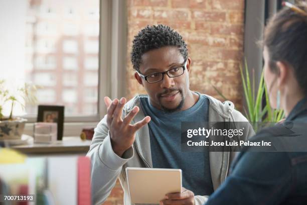 business people talking in office - meeting candid office suit stock-fotos und bilder