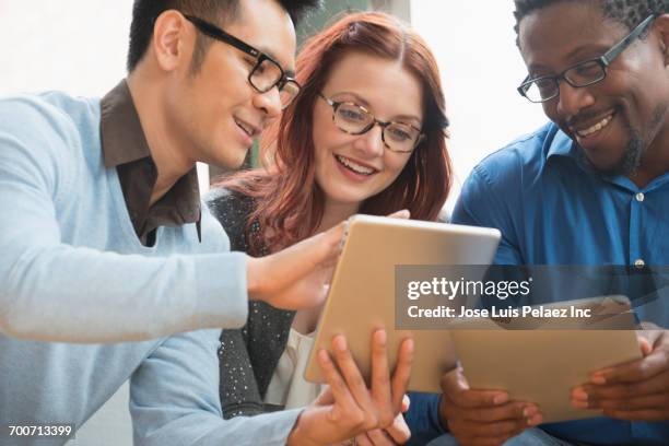 business people using digital tablets in office - african american and happy and close up and office stock pictures, royalty-free photos & images