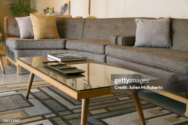 coffee table with glass and sectional sofa - coffee table books stockfoto's en -beelden