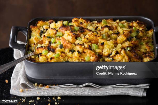 spoon in tray of stuffing - stuffing stock pictures, royalty-free photos & images