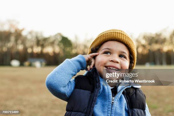 mixed race boy gesturing telephone in park - virginia beach 個照片及圖片檔