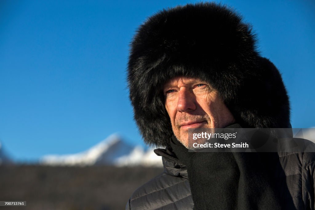 Caucasian man wearing scarf and fur hat in winter