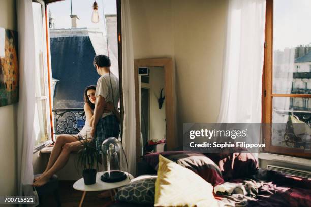 Caucasian Couple Hugging In Apartment Window, 照片檔