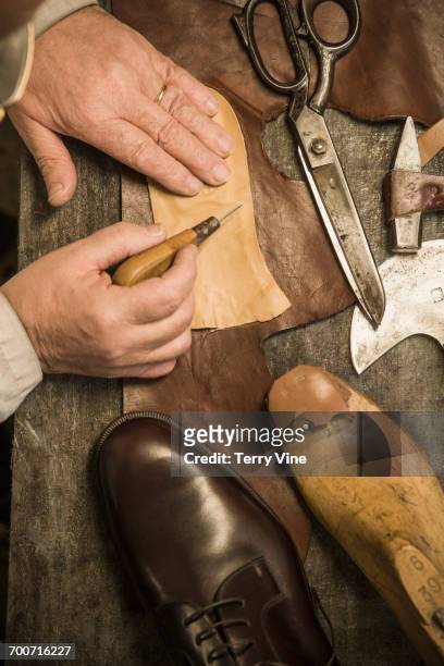 hands of shoemaker using awl on leather - maroquinerie photos et images de collection