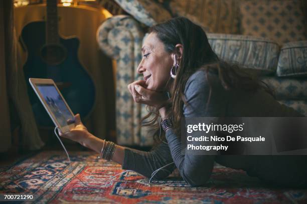 woman using digital tablet - tablet screen home stock-fotos und bilder