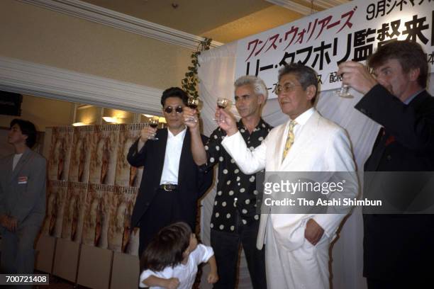 Film Director Lee Tamahori toasts glasses with film director Nagisa Oshima and actor Takeshi Kitano during a reception on July 26, 1995 in Tokyo,...