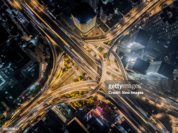 aerial view of road interchange at night - zhanjiang - fotografias e filmes do acervo