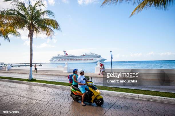 people on motorcycles on cozumel street, mexico - cozumel stock pictures, royalty-free photos & images