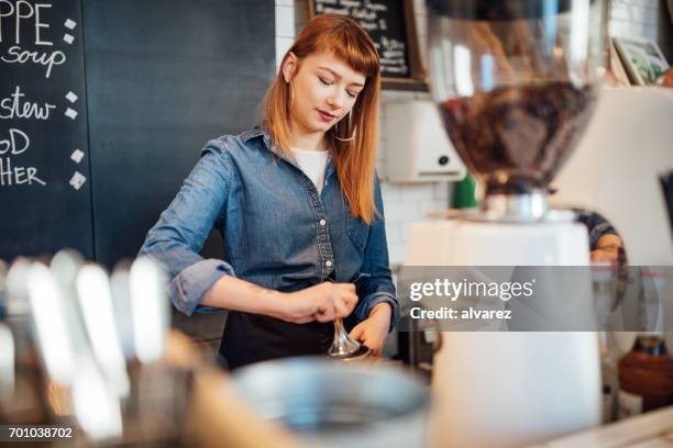 beautiful young barista making coffee at cafe - barista stock pictures, royalty-free photos & images