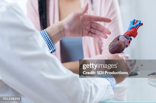Male cardiologist discusses diagnosis with patient Male cardiologist discusses diagnosis with patient