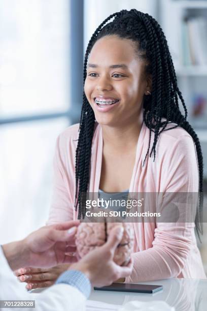 smiling teenage girl talks with doctor - organe de reproduction masculin imagens e fotografias de stock