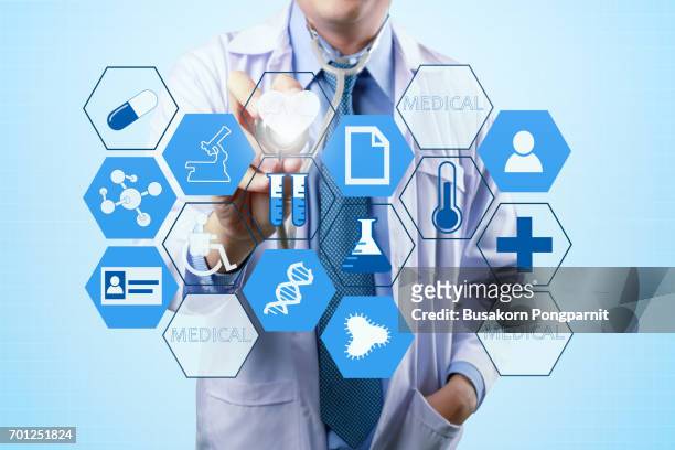 medical doctor touching virtual interface button of healthcare application - medical procedure icon stock pictures, royalty-free photos & images