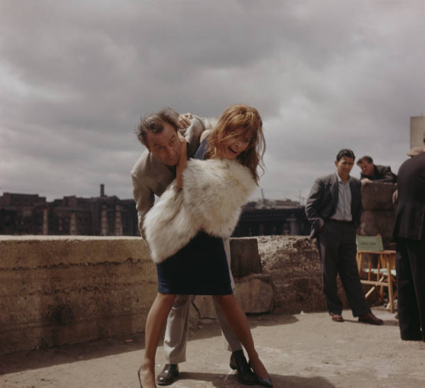 Italian actress Sophia Loren and English actor Dennis Price rehearse the scene for the film 'The Millionairess' in which she throws his character...