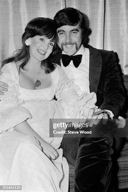 English actor John Alderton and his wife, actress Pauline Collins at the opening of film 'Please Sir', London, UK, 18th November 1971. Alderton stars...