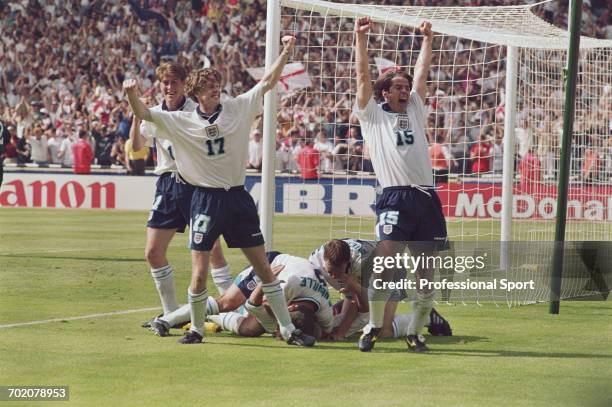 England footballers celebrate after Paul Gascoigne scored the winning goal against Scotland in the UEFA Euro 1996 Group A match between England and...