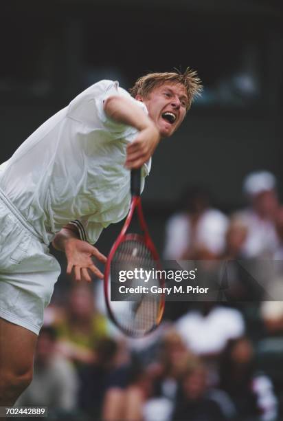 Yevgeny Kafelnikov of Russia serves against Mark Philippoussis during their First Round match of the Wimbledon Lawn Tennis Championship on 22 June...