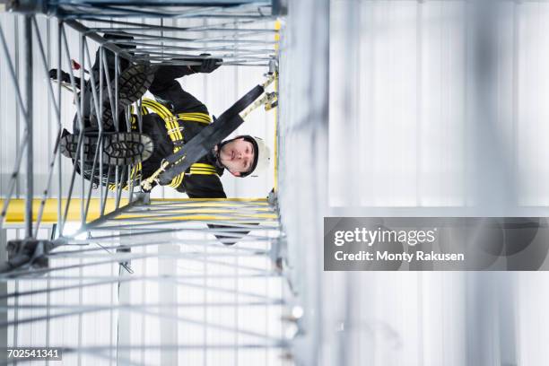 transmission tower engineer training to climb in training facility - telecoms engineer stock pictures, royalty-free photos & images