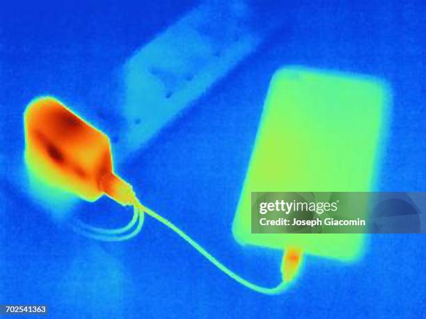 thermal image of smartphone, charging - thermal image stock-fotos und bilder