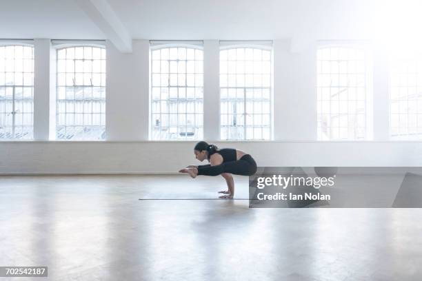 woman in dance studio in yoga position - yoga studio stock pictures, royalty-free photos & images