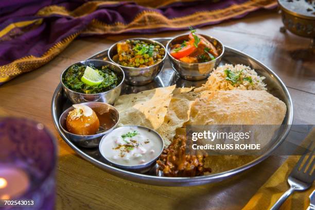 indian cuisine, thali bowls on restaurant table - indiase gerechten stockfoto's en -beelden