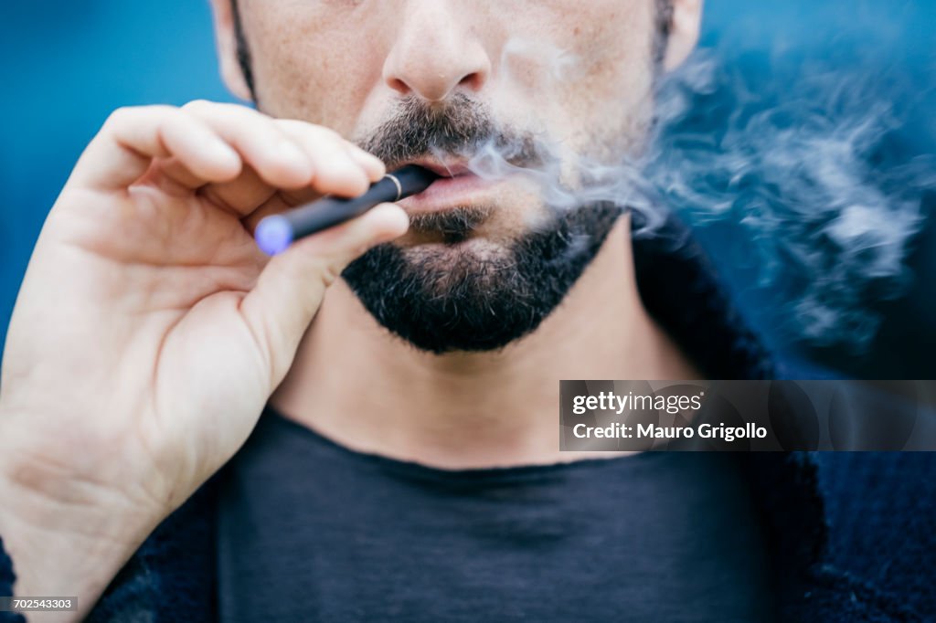 Portrait of man smoking an electronic cigarette