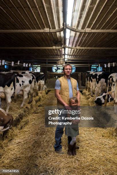portrait of farmer and daughter in cow shed - kids proud bildbanksfoton och bilder