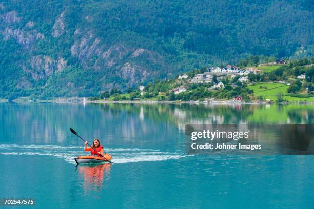 woman sea kayaking - rowboat stock pictures, royalty-free photos & images