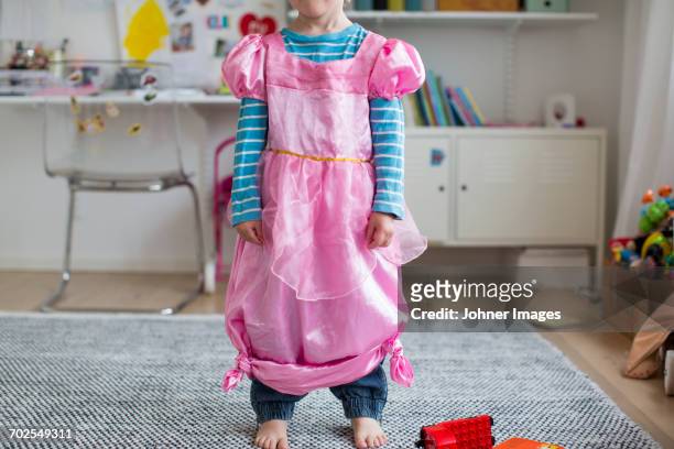 girl wearing fancy pink dress - gender stereotypes stock-fotos und bilder