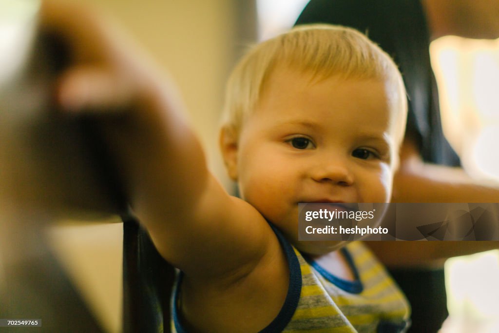 Portrait of young boy at home with father