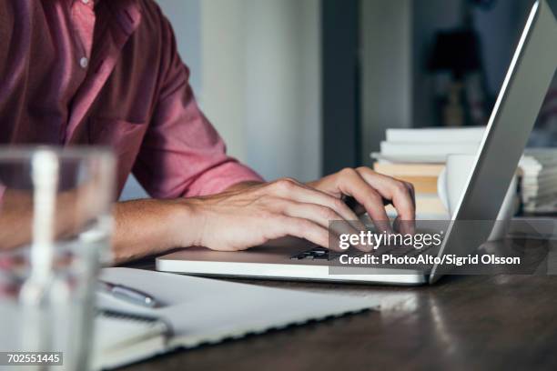 man typing on laptop computer, cropped - author ストックフォトと画像