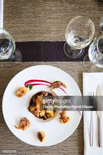 seafood dish garnished with fried calamari - dining presentation food imagens e fotografias de stock