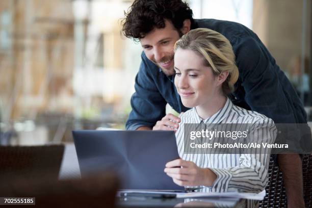 Using Computer With Partner 298 Laptop Couple Over Shoulder Stock Photos, High-Res Pictures, and ...