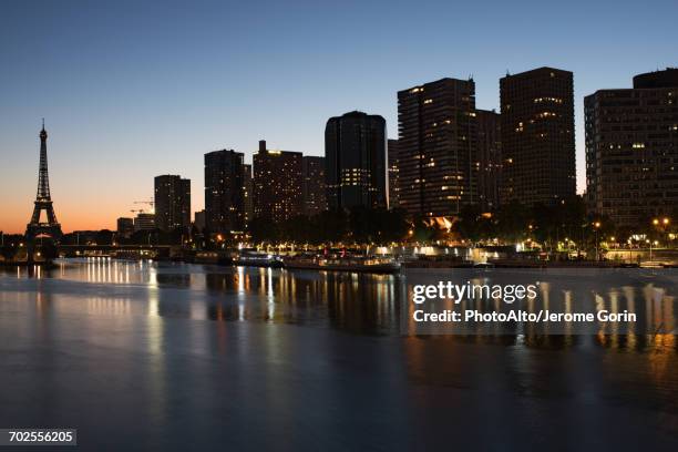 france, paris, buildings along the river seine at twilight - paris night stock pictures, royalty-free photos & images