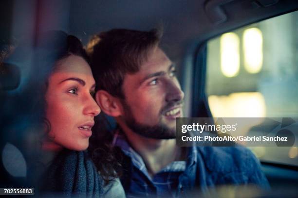 couple looking out car window at night - man awe stock pictures, royalty-free photos & images