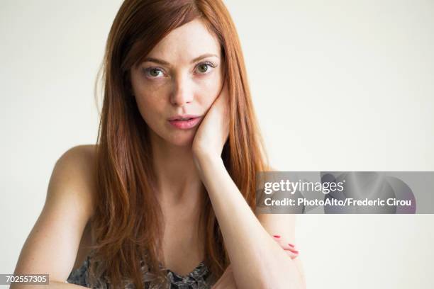 woman with hand under chin, portrait - 30 34 years stock pictures, royalty-free photos & images