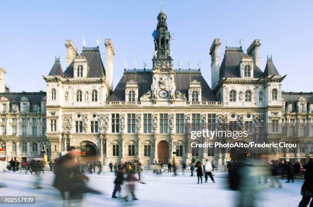 ice skating at hotel de ville ice rink, paris, france - rathaus von paris stock-fotos und bilder