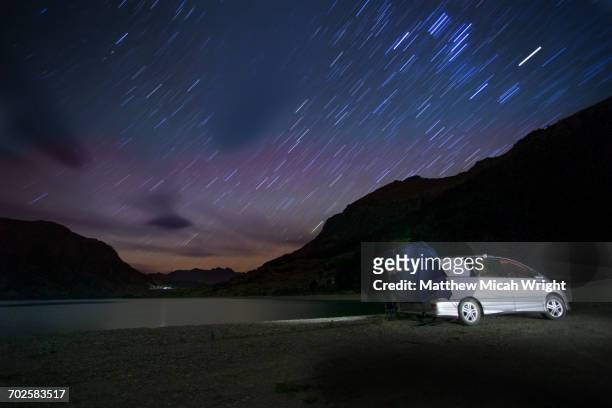 admiring the stars at night from a campsite. - camping new south wales stock pictures, royalty-free photos & images