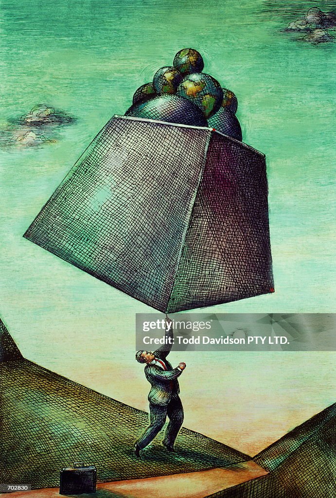 BUSINESSMAN BALANCING GLOBES ON HIS FINGER
