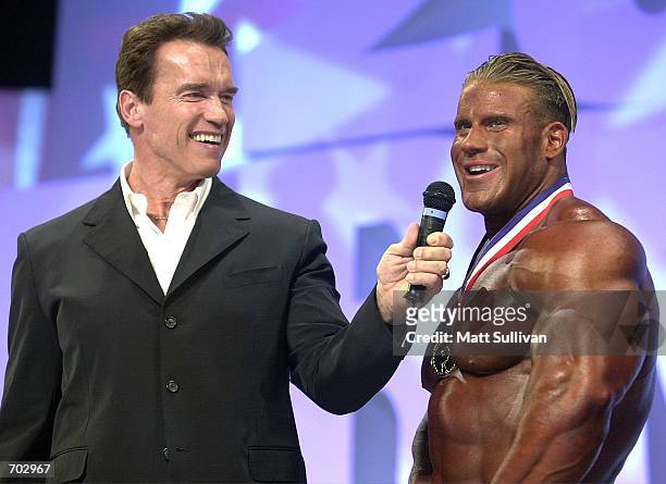 Actor and former bodybuilder Arnold Schwarzenegger talks with Jay Cutler, winner of The Arnold Classic 2002, February 23, 2002 in Columbus, OH.