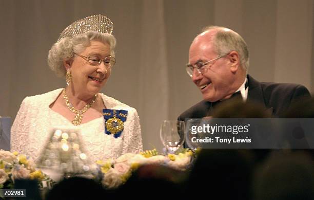 Britains Queen Elizabeth II chats with Prime Minister of Australia John Howard at a dinner at Festival Centre February 27, 2002 in Adelaide,...