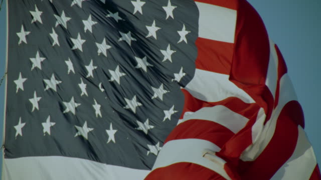 Slow motion close up American flag waving in breeze