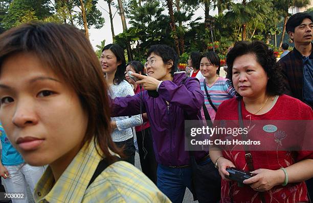 Chinese tourists gather at the Istana Negara, the official residence of the ceremonial King of Malaysia March 12, 2002 in Kuala Lumpur, Malaysia....