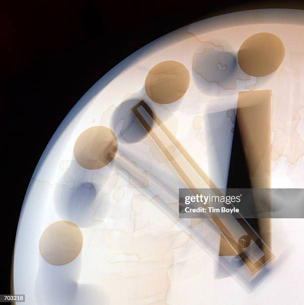 Using a slow camera exposure to simulate clock movement, the hands of the Bulletin of the Atomic Scientists "Doomsday Clock" are seen at 11:53 p.m,...