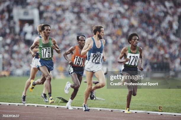 View of athletes competing in the final of the Men's 10,000 metres event, with bronze medal winner Mohamed Kadir of Ethiopia leading Lasse Viren of...