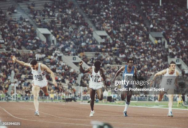 Scottish sprint athlete Allan Wells of the Great Britain team crosses the finish line in first place to win the final of the Men's 100 metres event...