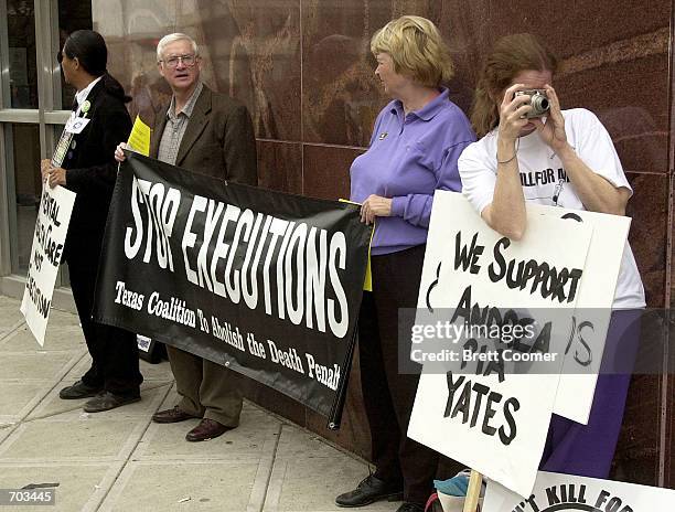 Death penalty opponent Peggy Connally , of Paradise, TX, takes a photo from her spot in front of the Harris County Courthouse during the punishment...