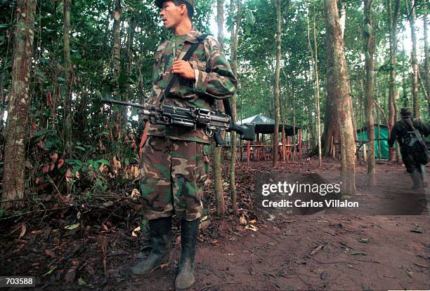 Revolutionary Armed Forces of Colombia guerrillas prepare weaponry inside their camp before leaving to set up road blockades February 28, 2002 in...