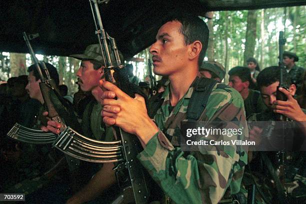 Revolutionary Armed Forces of Colombia guerrillas prepare plans to set up road blockades February 28, 2002 in Caqueta jungle, Colombia. Peace talks...