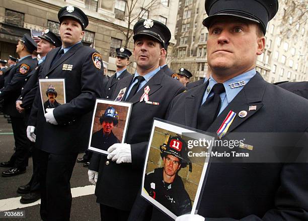 New York City firefighter Mike Heffernan holds a picture of his firefighter brother, John, who was killed in the September 11th World Trade Center...