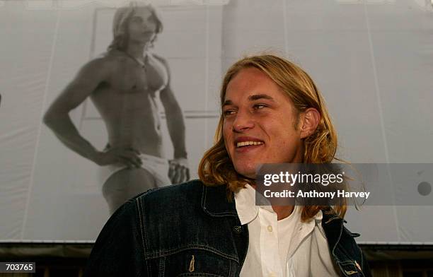 Australian model Travis Fimmel, the first new male face of Calvin Klein underwear for two years, looks at his image on a billboard March 1, 2002 on...